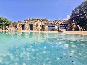 a building with a pool of water in front of it at Casa Campo Longo in Belgodère