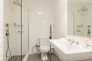 a bathroom with a toilet and a sink and a shower at 30m to Beach - Mindelo Ocean House in Mindelo +35 photos
