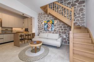 a living room with a couch and a staircase in a kitchen at PEA Plaka Authentic Home in Plaka Milou