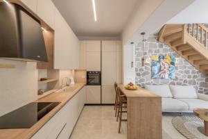 a kitchen and living room with a couch and a table at PEA Plaka Authentic Home in Plaka Milou +16 photos