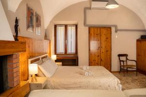 a bedroom with a bed and a chair in a room at La corte del Lago in Sulzano