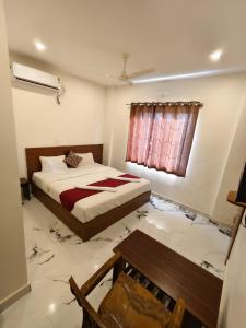 a bedroom with a bed and a smashed floor at Hotel Relax inn in Chikmagalūr