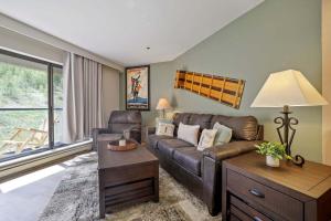 a living room with a couch and a table at Beaver Run Resort 4228 - Dog Friendly in Breckenridge