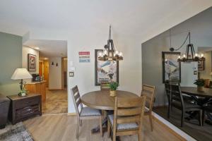 a dining room and living room with a table and chairs at Beaver Run Resort 4228 - Dog Friendly in Breckenridge