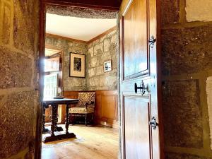 an entrance to a room with a piano and a table at Château de Lescure in Saint-Martin-sous-Vigouroux +100 photos