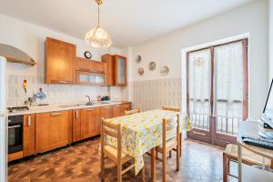 a kitchen with a table with chairs and a dining room at All'antico Peso in Demonte