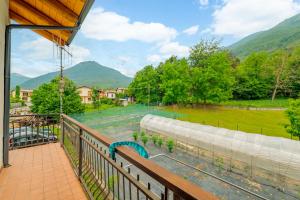 a balcony with a view of a field and mountains at All'antico Peso in Demonte