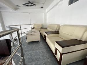 a living room with a couch and a table at YT Hotel & Hostel Vientiane in Vientiane