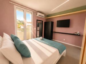 a bedroom with a large bed and a television at Social Lodge Happiness Studios in Funchal