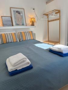 a bed with towels sitting on top of it at Kalithea Palekastro in Palekastron