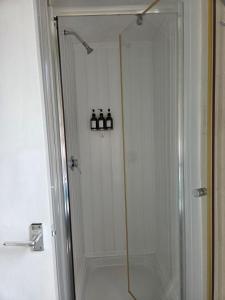 a shower with a glass door in a bathroom at Glendor Hotel in Blackpool