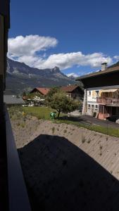 a view of a patio with a mountain in the background at Sous les Capucines in Saint-Gervais-les-Bains