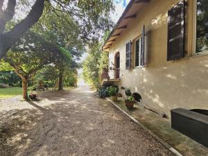 a house with a driveway next to a building at Villa Carla - vicino alla Riviera del Conero e ai Colli dell' Infinito in Ancona