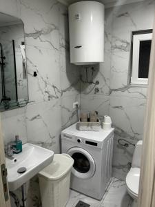 a bathroom with a washing machine and a sink at Apartment Vucetic in Sutvara