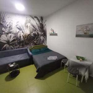 a room with a couch and a wall with a mural at Sky Apartments Petrovac in Petrovac na Moru +29 photos