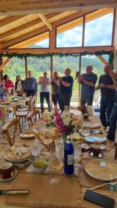 a group of people standing around a long table at Muntele cu dor in Crevileşti