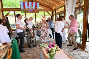 a group of people standing around a table in a room at Muntele cu dor in Crevileşti