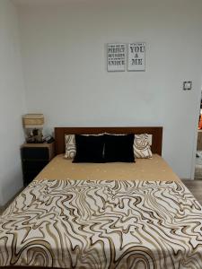 a bedroom with a bed with a zebra print bedspread at Apartman Pejovic N in Smederevo