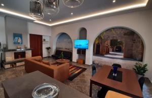 a living room with a couch and a tv at Dorian in Kos