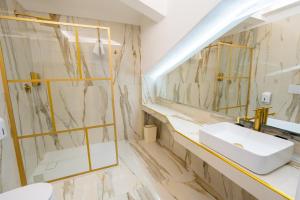 a bathroom with a sink and a mirror at Letoh Apartment in Catania