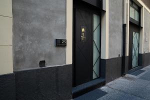 a black door on a building with the number twenty four at Letoh Apartment in Catania