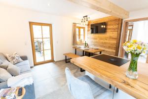 a living room with a table and a couch at Chalet Kogelleiten in Ramsau