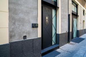 a door on the side of a building with the number four at Letoh Apartment in Catania