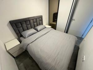 a bedroom with a large bed with a white bedspread at Apartment Balkan in Modriča