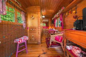 a room with chairs and tables in a train room at Roulotte du Rouard in Camiers