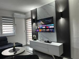 a living room with a couch and a table at Apartment Balkan in Modriča