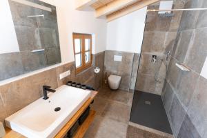 a bathroom with a sink and a shower at Chalet Kogelleiten in Ramsau +108 photos