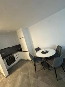 a kitchen with a table and chairs in a room at Apartment Balkan in Modriča