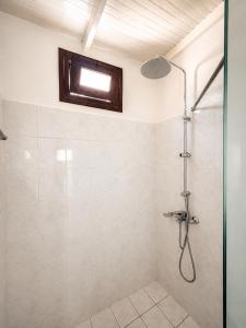 a bathroom with a shower with a glass door at Peyia traditional house in Paphos