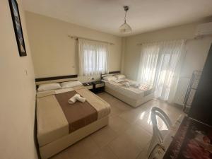 a bedroom with two beds in a room at VILLA HARIKLIA in Paralia Katerinis