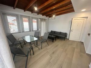 a living room with a table and chairs and a couch at VILLA HARIKLIA in Paralia Katerinis