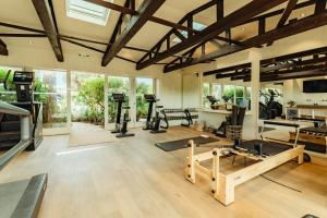 a gym with treadmills and exercise equipment in a room at Epi Baie de Pampelonne in Saint-Tropez