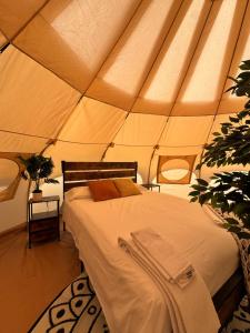 a bedroom with a bed in a tent at Prairie Junction Glamping Tent in Stettler