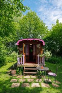 a small house with a table and a tableasonable at Roulotte du Rouard in Camiers