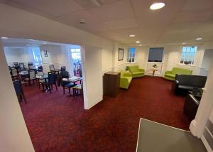 a room with chairs and tables and a waiting room at Torpark hotel in Torquay