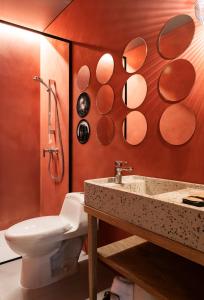 a bathroom with a toilet and a sink at Obra Hotels in Medellín +21 photos