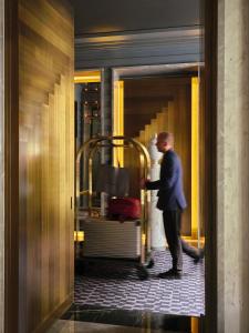a man standing in a doorway with a bride at Nolinski Paris - Evok Collection in Paris