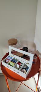 a small red table with a white box on it at City & Forest Relax Room with Private Sauna & Garden in Espoo +13 photos