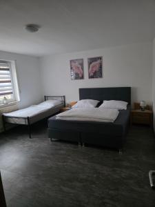 a bedroom with two beds and a window at Haus Raab in Knetzgau