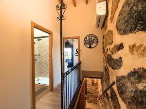 a staircase in a home with a stone wall at YourHouse A Casa Do Cordeiro in Allariz