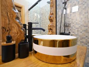 a bathroom with a round sink on a wooden counter at YourHouse A Casa Do Cordeiro in Allariz +20 photos