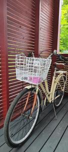 a bicycle with a basket parked on a porch at City & Forest Relax Room with Private Sauna & Garden in Espoo