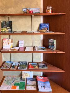 a book shelf with many books on it at Pieve Antica in Piazza