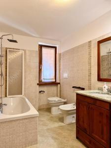 a bathroom with a tub and a toilet and a sink at Pieve Antica in Piazza +21 photos