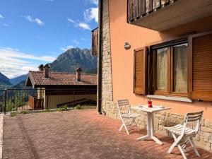 a patio with a table and chairs on the side of a house at Pieve Antica in Piazza