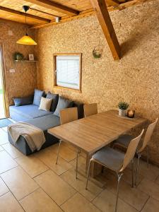 a living room with a table and a couch at Bungalow Perun in Blejska Dobrava